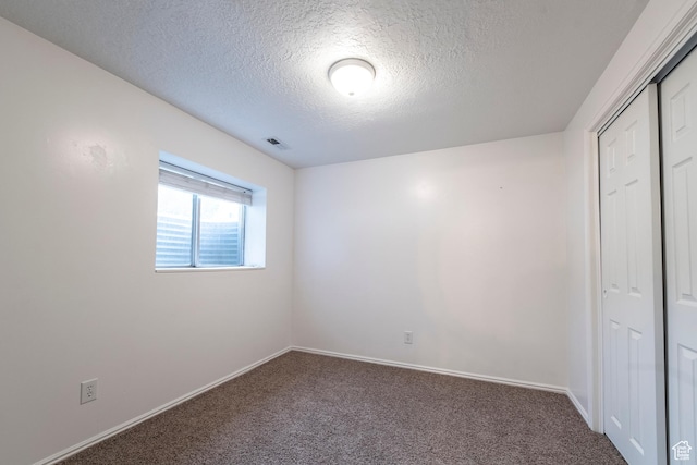 2979 W 4275 S, Roy, UT 84067 - unfurnished bedroom featuring carpet floors, a textured ceiling, a closet, and baseboards