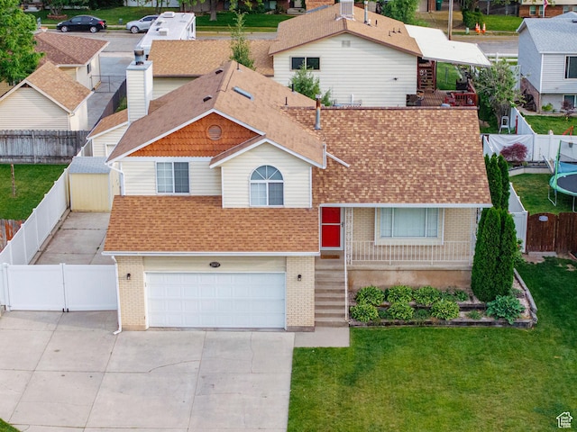 2979 W 4275 S, Roy, UT 84067 - view of front of house with brick siding, roof with shingles, driveway, an attached garage, and a gate