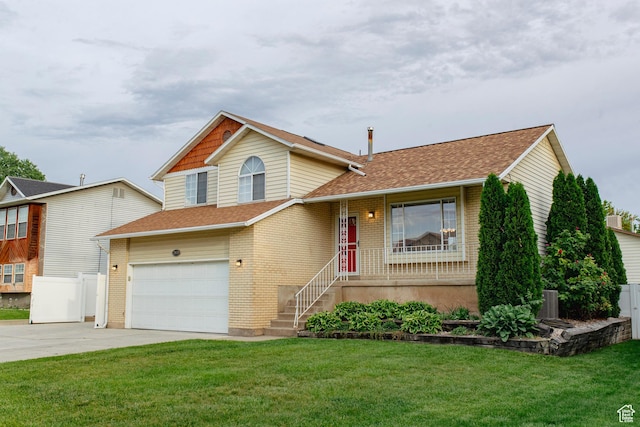 2979 W 4275 S, Roy, UT 84067 - tri-level home featuring concrete driveway, a garage, a front lawn, and brick siding