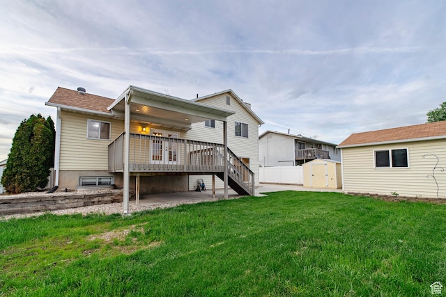 2979 W 4275 S, Roy, UT 84067 - rear view of house featuring a patio, a wooden deck, a yard, and stairway