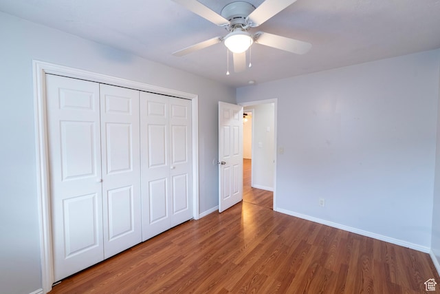 2979 W 4275 S, Roy, UT 84067 - unfurnished bedroom featuring wood finished floors, baseboards, a closet, and a ceiling fan