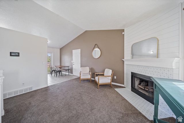 6262 W Contadora Dr S, West Valley City, UT 84128 - living area with a tile fireplace, carpet floors, vaulted ceiling, and baseboards