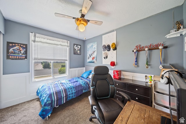 6262 W Contadora Dr S, West Valley City, UT 84128 - bedroom with carpet, a desk, a wainscoted wall, a textured ceiling, and a ceiling fan