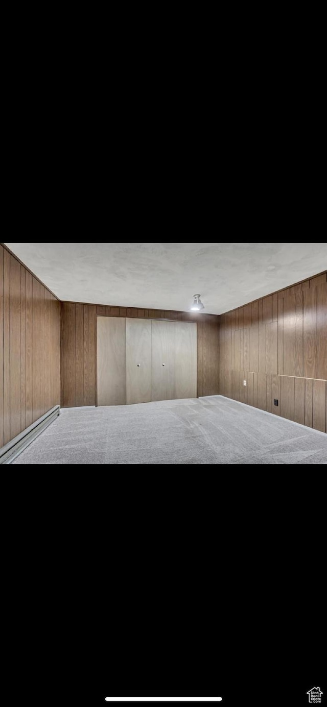 5540 S 850 E Unit 38, South Ogden, UT 84405 - interior space with wood walls and a baseboard heating unit