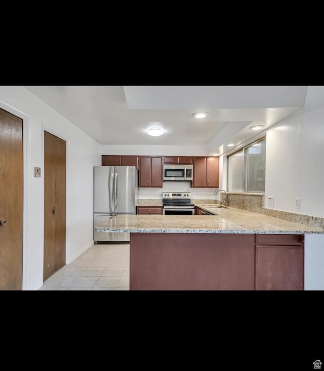 5540 S 850 E Unit 38, South Ogden, UT 84405 - kitchen with stainless steel appliances, a sink, a peninsula, light tile patterned floors, and light stone counters