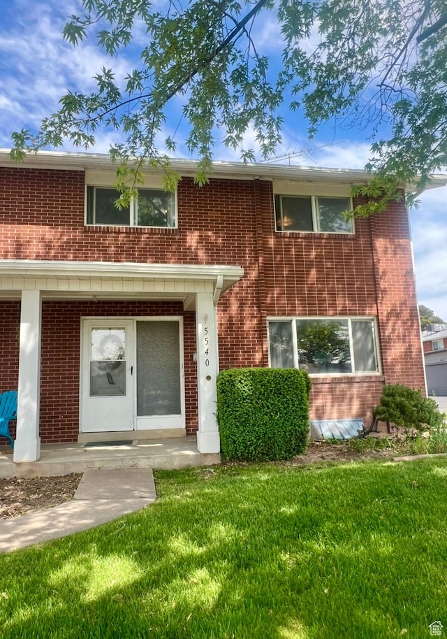 5540 S 850 E Unit 38, South Ogden, UT 84405 - view of front of house featuring brick siding and a front lawn