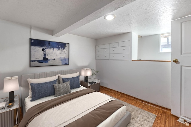 806 E Canyon Rd, Ogden, UT 84404 - bedroom with wood finished floors, a textured ceiling, and beamed ceiling