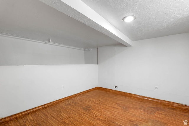 806 E Canyon Rd, Ogden, UT 84404 - finished below grade area featuring wood finished floors, a textured ceiling, and baseboards