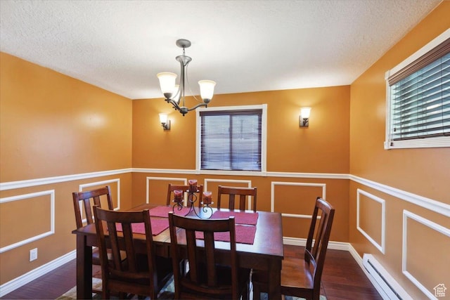 320 E 4600 S, Washington Terrace, UT 84405 - dining space featuring a chandelier, wood finished floors, plenty of natural light, wainscoting, and a baseboard heating unit