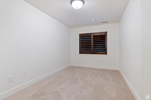 1918 W City Village Way Unit 140, Riverton, UT 84065 - spare room featuring light carpet, a textured ceiling, and baseboards
