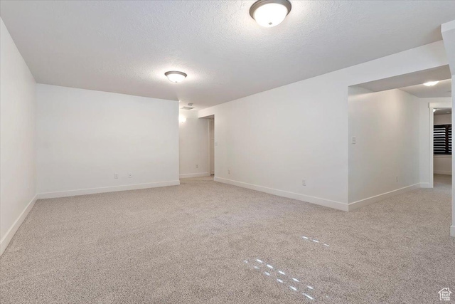 1918 W City Village Way Unit 140, Riverton, UT 84065 - spare room featuring light colored carpet, a textured ceiling, and baseboards