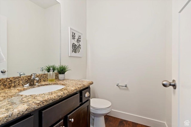 1918 W City Village Way Unit 140, Riverton, UT 84065 - bathroom featuring vanity, wood finished floors, baseboards, and toilet