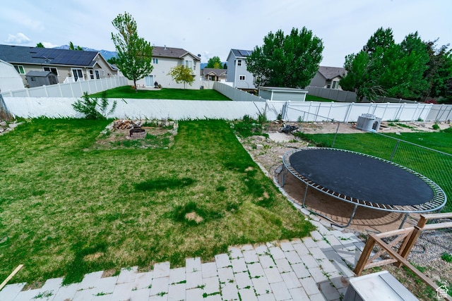 1542 N 2530 W, Clinton, UT 84015 - view of yard featuring a trampoline, an outdoor fire pit, and a residential view