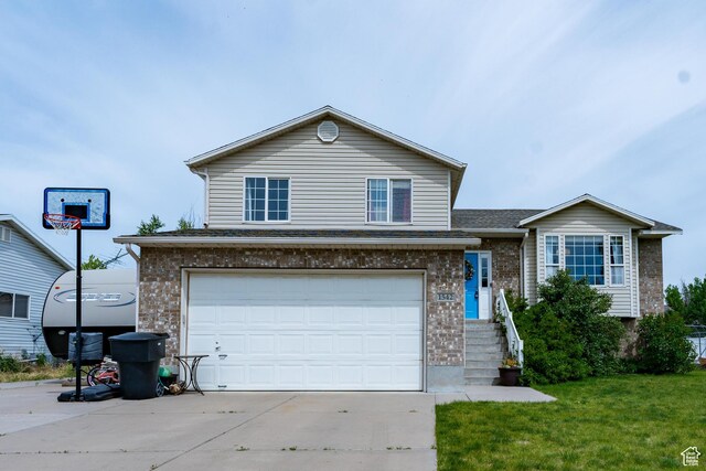 1542 N 2530 W, Clinton, UT 84015 - view of front of home featuring driveway, brick siding, a garage, and a front yard