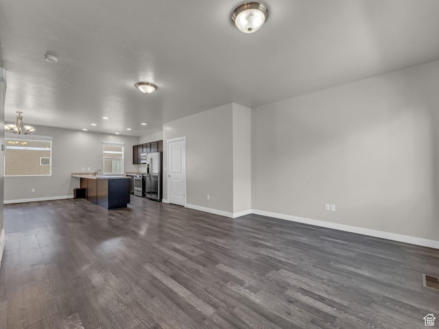 3671 W Sunrise Sky Ln Unit 1022, South Jordan, UT 84009 - unfurnished living room with a chandelier, dark wood-type flooring, baseboards, and recessed lighting
