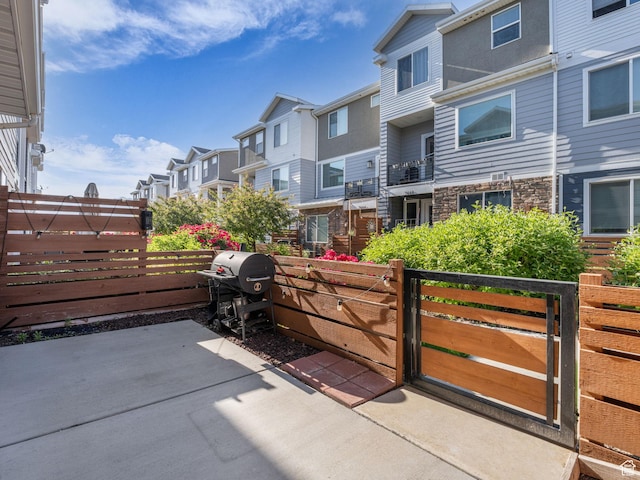 3671 W Sunrise Sky Ln Unit 1022, South Jordan, UT 84009 - view of patio / terrace featuring a residential view, a grill, and a gate