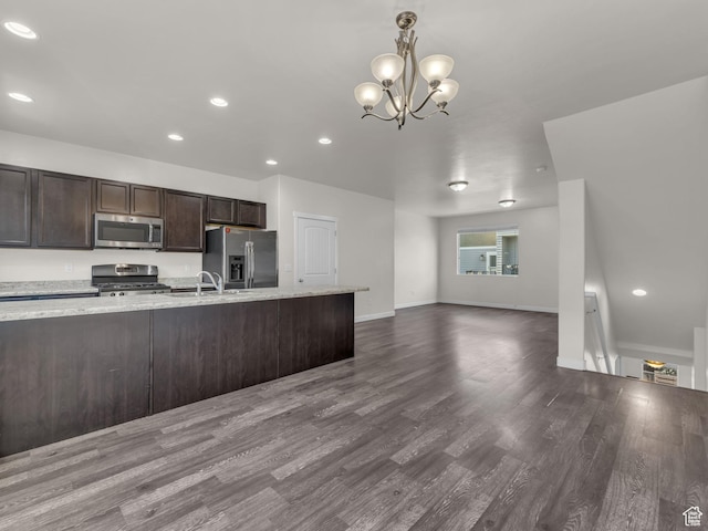 3671 W Sunrise Sky Ln Unit 1022, South Jordan, UT 84009 - kitchen with appliances with stainless steel finishes, dark brown cabinets, dark wood-style flooring, a chandelier, and baseboards