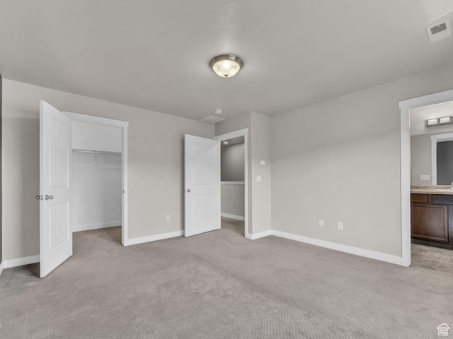 3671 W Sunrise Sky Ln Unit 1022, South Jordan, UT 84009 - unfurnished bedroom featuring light carpet, baseboards, a spacious closet, and ensuite bath