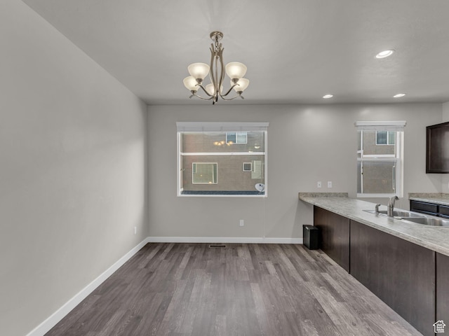 3671 W Sunrise Sky Ln Unit 1022, South Jordan, UT 84009 - unfurnished dining area with a sink, dark wood finished floors, baseboards, a chandelier, and recessed lighting