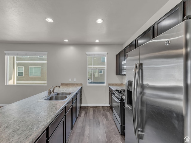 3671 W Sunrise Sky Ln Unit 1022, South Jordan, UT 84009 - kitchen featuring stainless steel appliances, a sink, dark wood finished floors, recessed lighting, and light countertops