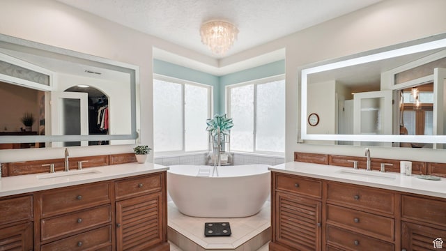 372 N Waterside Rd W, Heber City, UT 84032 - bathroom with two vanities, a freestanding bath, and a chandelier