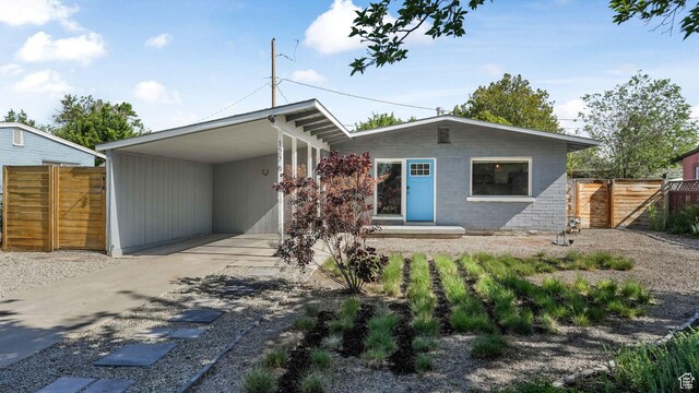 1276 W 1100 N, Salt Lake City, UT 84116 - view of front facade featuring driveway, an attached carport, and a gate