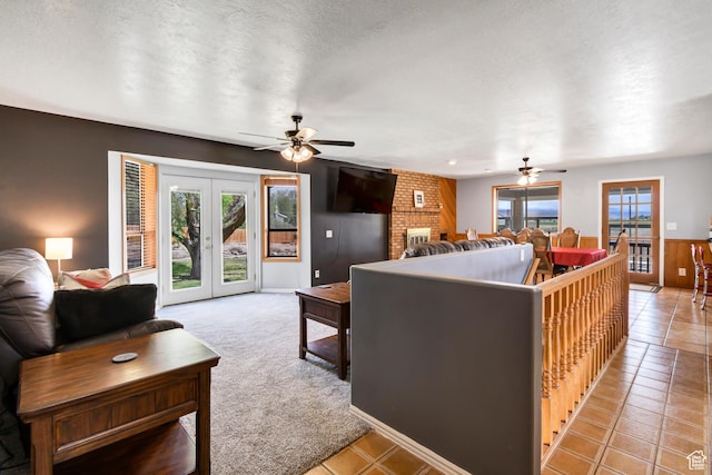 155 S 200 W, Gunnison, UT 84634 - living area featuring a ceiling fan, french doors, light tile patterned flooring, light carpet, and a textured ceiling