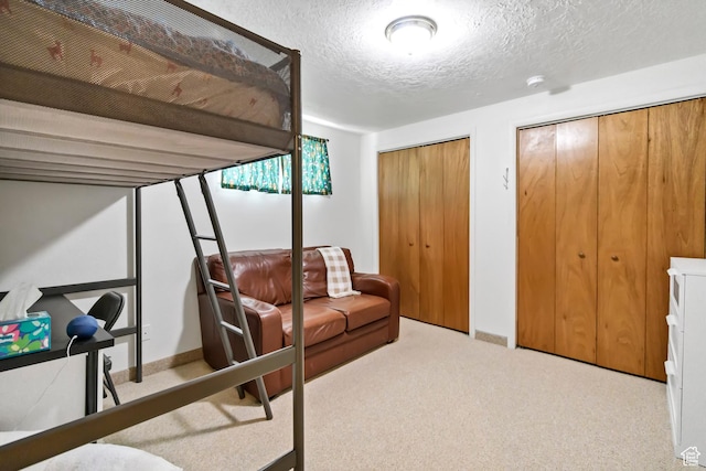 155 S 200 W, Gunnison, UT 84634 - carpeted bedroom with two closets, a textured ceiling, and baseboards