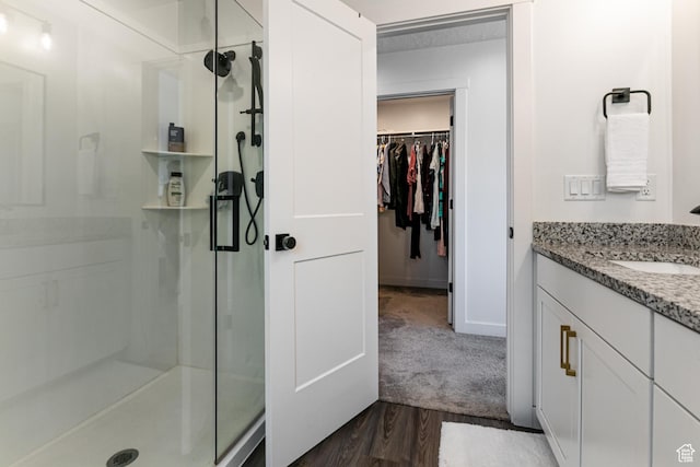 849 N Evelyn St W, Farmington, UT 84025 - full bathroom with a shower stall, vanity, a walk in closet, wood finished floors, and baseboards