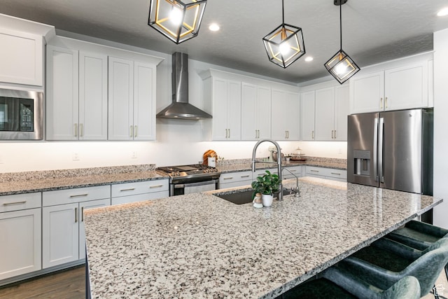 849 N Evelyn St W, Farmington, UT 84025 - kitchen featuring wall chimney exhaust hood, appliances with stainless steel finishes, a sink, a breakfast bar area, and recessed lighting