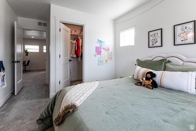 849 N Evelyn St W, Farmington, UT 84025 - bedroom featuring multiple windows, a walk in closet, carpet floors, and baseboards