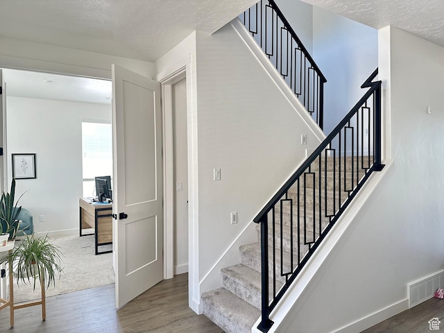 849 N Evelyn St W, Farmington, UT 84025 - stairs featuring wood finished floors, a textured ceiling, and baseboards