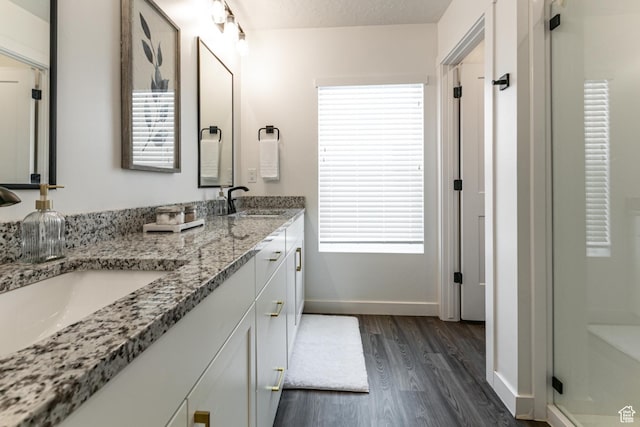 849 N Evelyn St W, Farmington, UT 84025 - full bathroom featuring wood finished floors, baseboards, double vanity, and a shower stall