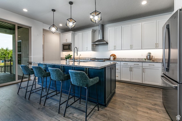 849 N Evelyn St W, Farmington, UT 84025 - kitchen with wall chimney range hood, appliances with stainless steel finishes, a sink, dark wood-style flooring, and white cabinets