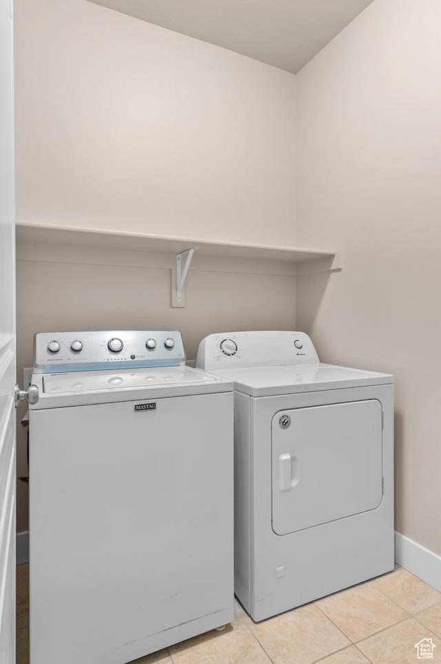 4908 W Duckhorn Dr, South Jordan, UT 84009 - laundry area with washing machine and clothes dryer, light tile patterned flooring, and baseboards