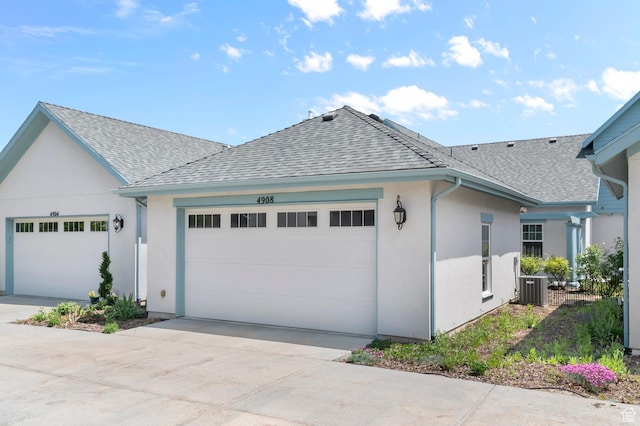 4908 W Duckhorn Dr, South Jordan, UT 84009 - view of side of home featuring roof with shingles, a garage, central air condition unit, stucco siding, and driveway