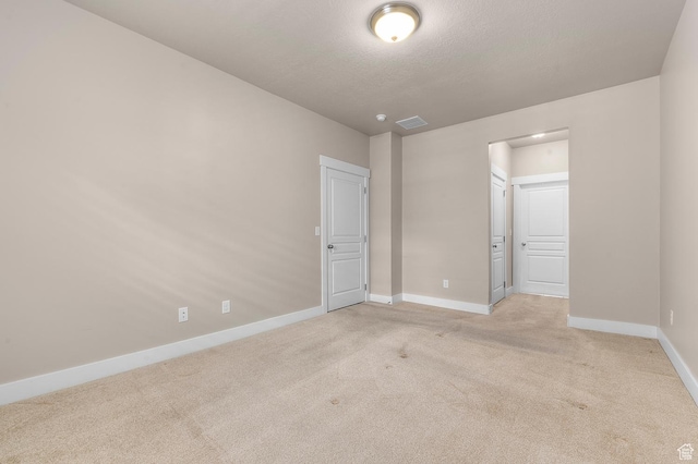 4908 W Duckhorn Dr, South Jordan, UT 84009 - unfurnished bedroom with light carpet, baseboards, a textured ceiling, and connected bathroom