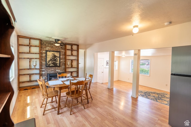 476 Cliffview Dr, Moab, UT 84532 - dining room featuring a ceiling fan, wood finished floors, a fireplace, and built in features