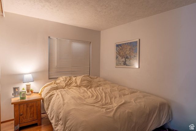 476 Cliffview Dr, Moab, UT 84532 - bedroom featuring wood finished floors and a textured ceiling