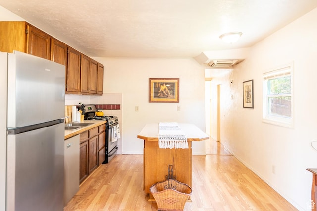476 Cliffview Dr, Moab, UT 84532 - kitchen with stainless steel appliances, light countertops, light wood-style flooring, and brown cabinetry