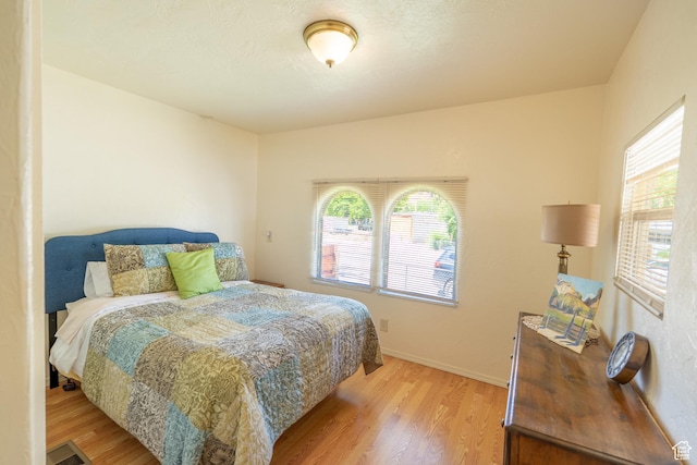 476 Cliffview Dr, Moab, UT 84532 - bedroom featuring light wood-style floors, multiple windows, and baseboards