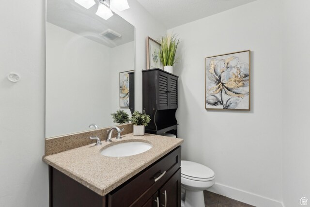 1792 S Laurelhurst Dr E, Salt Lake City, UT 84108 - half bath with vanity, toilet, tile patterned floors, a skylight, and baseboards