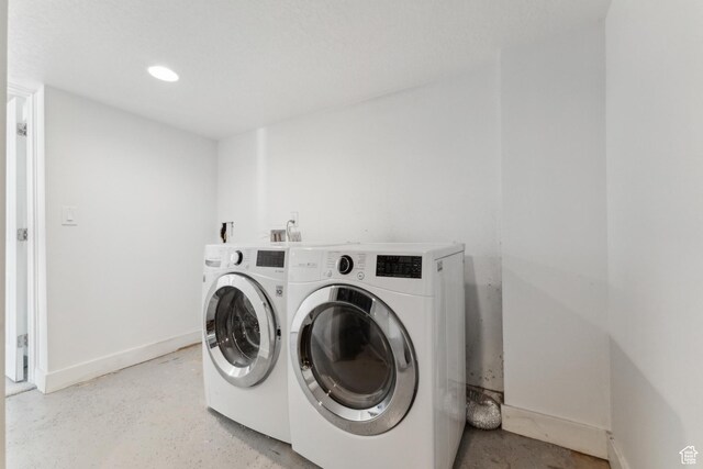 1792 S Laurelhurst Dr E, Salt Lake City, UT 84108 - laundry area with washer and dryer, baseboards, and recessed lighting