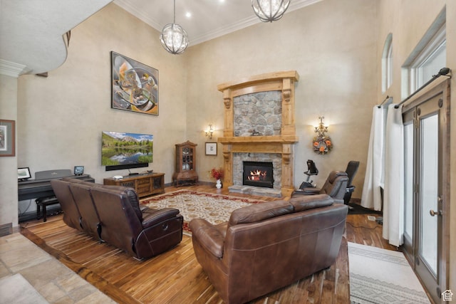 13302 S Corner Wood Dr E, Draper, UT 84020 - living room featuring crown molding, plenty of natural light, a towering ceiling, and a fireplace