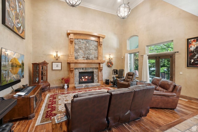 13302 S Corner Wood Dr E, Draper, UT 84020 - living room with a high ceiling, wood-type flooring, ornamental molding, a fireplace, and baseboards