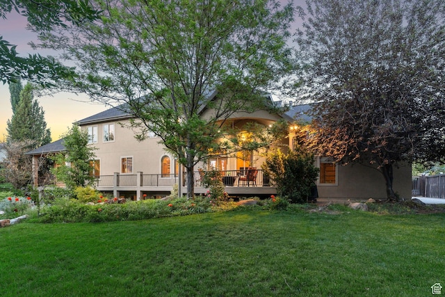 13302 S Corner Wood Dr E, Draper, UT 84020 - rear view of property featuring a yard, a wooden deck, and stucco siding