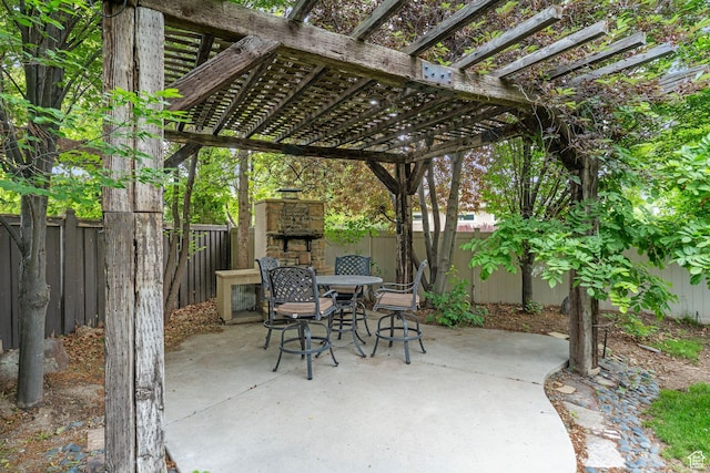 13302 S Corner Wood Dr E, Draper, UT 84020 - fenced backyard with an outdoor stone fireplace, a patio area, outdoor dining area, and a pergola