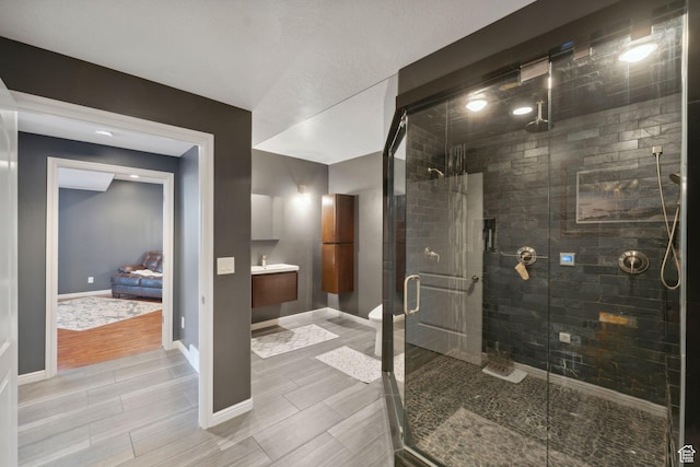 13302 S Corner Wood Dr E, Draper, UT 84020 - full bath with wood tiled floors, a stall shower, baseboards, and vanity