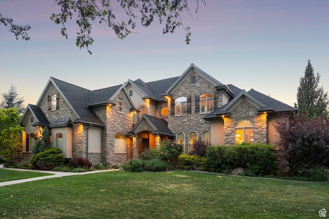 13302 S Corner Wood Dr E, Draper, UT 84020 - view of front facade featuring stone siding, a lawn, and stucco siding