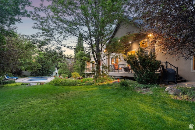 13302 S Corner Wood Dr E, Draper, UT 84020 - yard at dusk with a deck, a yard, and a hot tub